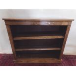 A Victorian figured walnut open bookcase fitted with two adjustable shelves, 107 cm wide