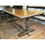 A 19th century oak refectory table, the plank top with carved borders, raised on a pair of