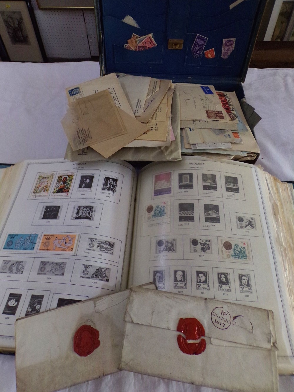 A small suitcase containing a quantity of unsorted loose stamps, documents and postal history,