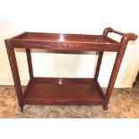 A Chinese hardwood two tier tea trolley of rectangular form, the borders and supports with dragon