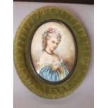 An oval miniature portrait showing a lady in late 18th century style costume, indistinctly signed,