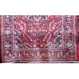 Persian Hammerdan rug with central dark floral medallion and further floral sprays upon a red
