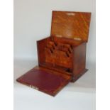 Early 20th century oak campaign type desk cabinet, the hinged lid enclosing a waterfall letter