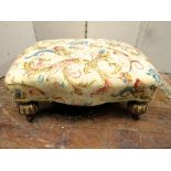 A good quality 19th century foot stool, raised on four fluted and gilded bun feet, with shaped