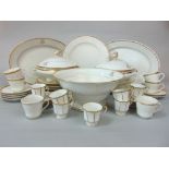 A quantity of late 19th century white and gilt dinnerwares with gilt monogram detail including a