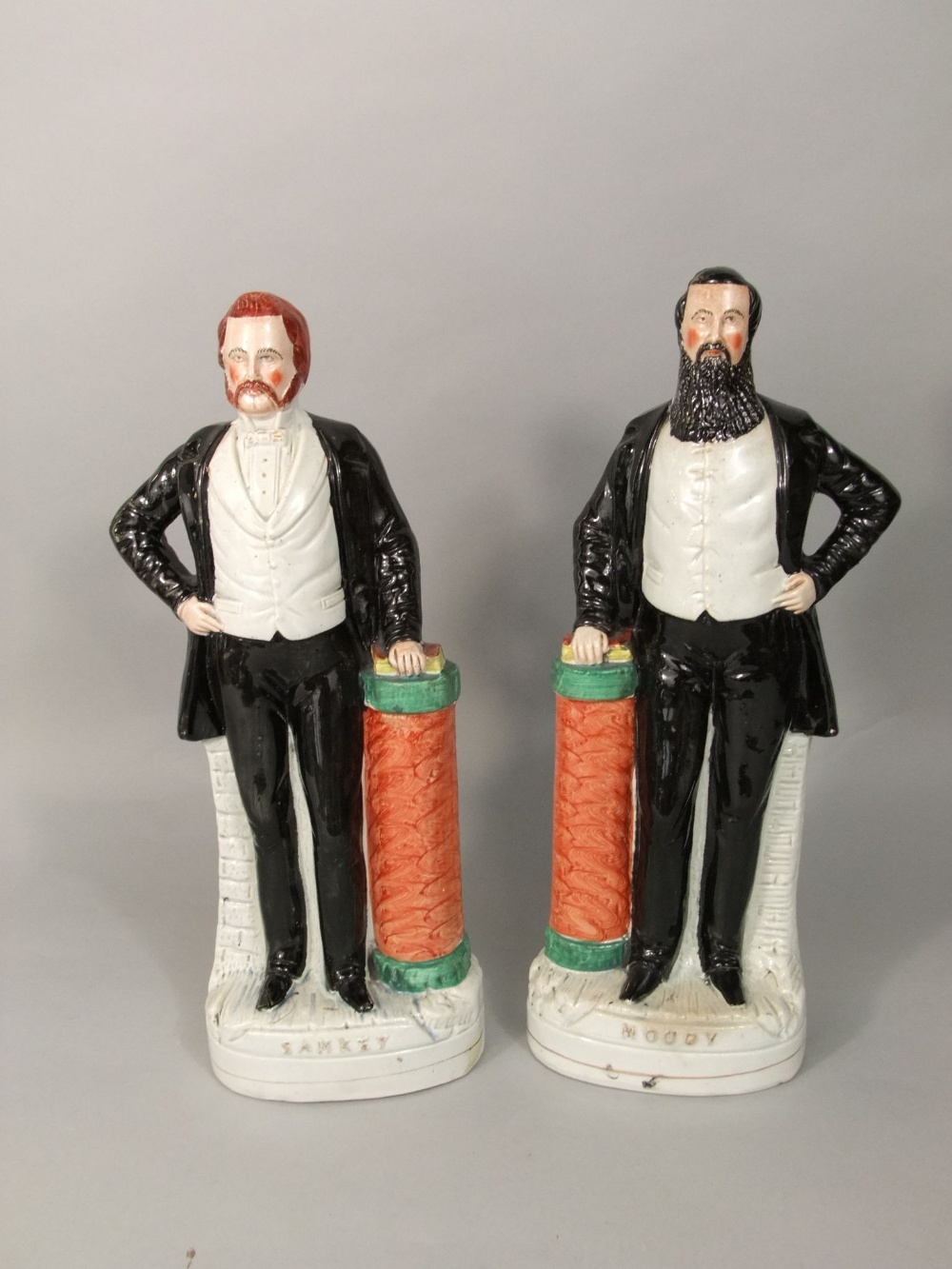 A pair of 19th century Staffordshire figures of Moody and Sankey, both with moulded titles to front,