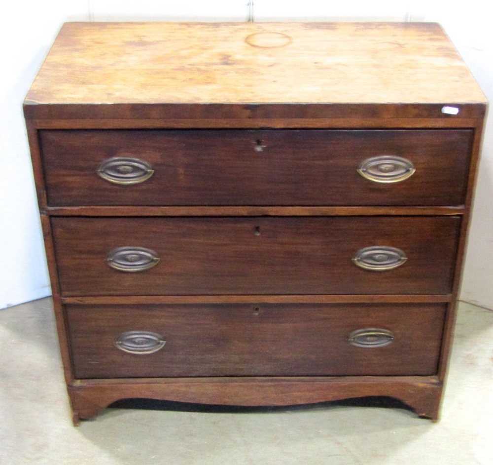 A small 19th century mahogany caddy top bedroom chest of three long graduated drawers with shaped