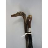 Ebonised walking cane with horn knop and silver band, together with a further naturalistic