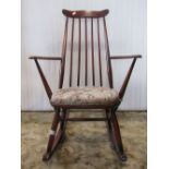 A vintage dark stained Ercol Windsor stickback armchair with stained beechwood frame, together