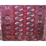 Small Bokhara rug/prayer mat, with typical decoration upon a deep red ground, 120 x 90cm