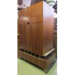 A good quality freestanding retro style entertainment cabinet enclosed by three doors, and a long