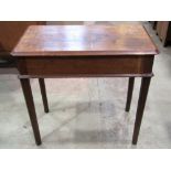 An Arts & Crafts oak side table of rectangular form with moulded outline over a full length end