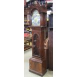A contemporary reproduction longcase clock with architectural hood enclosing a brass arched dial