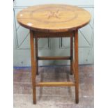 An oak country made table, the circular top inlaid with central star burst and other detail,