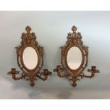 A pair of twin branch Girondelle wall mirrors in the Regency manner with typical decoration of