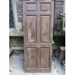 A reclaimed partially stripped Georgian oak door enclosing six fielded panels, 195 cm high x 79 cm