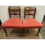 A set of six Regency mahogany dining chairs with shaped and carved splats, upholstered seats and