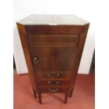 A Georgian mahogany commode with rising lid revealing a segmented interior, two drawers, disguised