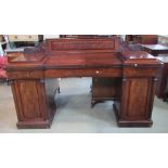 A 19th century mahogany twin pedestal sideboard with well matched flame veneers, shallow raised
