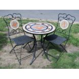 A contemporary three piece garden terrace set comprising a table of circular form inset mosaic top