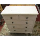 A pine bedroom chest of two short over three long drawers with moulded detail, decorative pumpkin