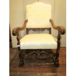 A 19th century elbow chair in the Carolean manner, the scrolled arms with acanthus detail, the front