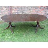 A good quality reproduction Regency style mahogany D end twin pillar dining table with single