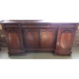 A Victorian mahogany shallow inverted breakfront four door sideboard with well matched flame veneers