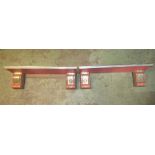 A pair of small decorative wooden wall shelves with painted finish, moulded outline and scrolled