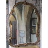 A large shield shaped wall mirror with moulded and scrolling acanthus gilt frame, 100cm x 70cm