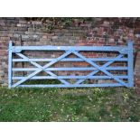 A traditional wooden farm five bar gate with later blue painted finish, approx 10ft long