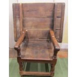 An early oak monks chair, the folding back/table top raised on turned supports with plank seat 103