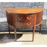 An Edwardian mahogany demi-lune side table, the two central drawers flanked by two cupboards with