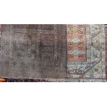 Antique village rug with various symbols upon a brown ground, 220 x 135cm, together with a further