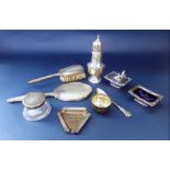 A mixed collection of silver to include a squat baluster caster, a silver lidded inkwell, a cast
