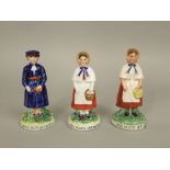 A pair of late 19th century Staffordshire figures of Red Maid Bristol and Colston Boy Bristol,