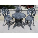 A Victorian style painted cast aluminium garden terrace table of circular form with decorative