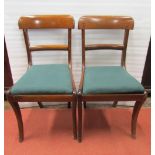 A set of six early 19th century mahogany sabre leg dining chairs with drop in seats, together with a