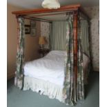 A late Regency/William IV pale mahogany four poster bedstead, the turned foot posts of tapering form