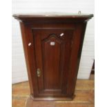 Georgian oak hanging corner cupboard of narrow dimensions 55 cm, enclosed by a fielded panelled door