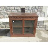 A 19th century oak and glazed side cabinet, with trailing geometric detail, 87cm wide, beneath a