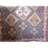 Turkish full pile rug with geometric medallions upon a blue ground, 200 x 145cm