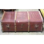 A 19th century domed top trunk, overlaid in oil skin with studded detail and side carrying handles