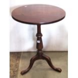 A 19th century mahogany occasional table, the circular top raised on a turned pillar and tripod,
