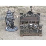 A pair of 19th century iron andirons with mushroom shaped finials, a cast iron boot scraper with