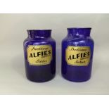 Pair of blue glass advertising jars 'Traditional Alfie's Barber, London W1' with gilt highlights,