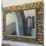 A 19th century gilt wood wall mirror of rectangular form, with scrolling acanthus and repeating