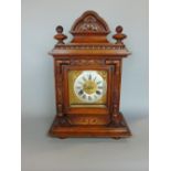 Late 19th/early 20th century Ansonia mantel clock, the carved case with bevelled glass over a two