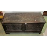 A late Victorian oak coffer/blanket chest with hinged lid and carved acanthus and further detail