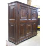 18th century or earlier oak court cupboard enclosed by an arrangement of three cupboard doors and